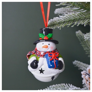 Detailed view of a snowman Christmas bell ornament with a black hat on a snowy pine tree
