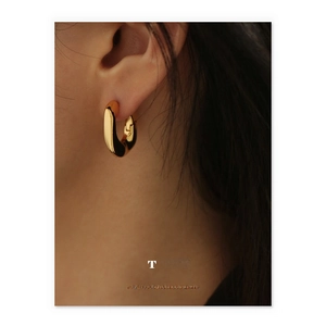 Minimalist 18K gold plated brass hoop earrings shown on a model for a luxury look