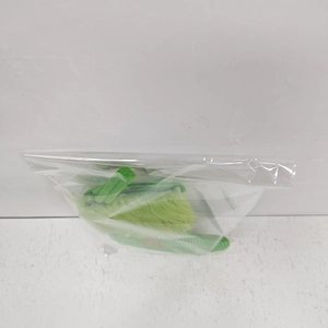 Close-up of green plush Christmas stocking in protective packaging for DIY holiday decor
