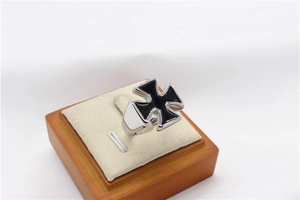 Close-up of cross ring with black enamel inlay on a professional display stand