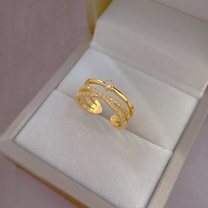 Detail of layered gold crisscross ring with micro-pave cubic zirconia accents