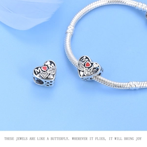 Detail of S925 sterling silver MOM heart charm with red stones on snake chain