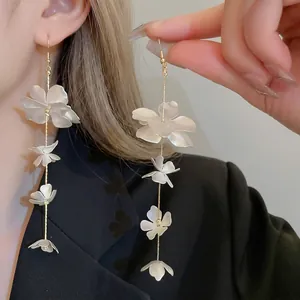 Elegant long tassel earrings with white 3D flowers and golden chains for women