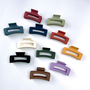 Detailed view of large matte square hair claws in a variety of vibrant fashion colors
