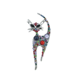 Detailed close-up showing vibrant multi-color rhinestones on a vintage cat-shaped metal brooch