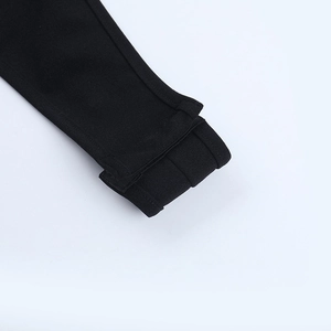 Close-up of the fine sewing and high-quality knitted fabric on the black bodysuit sleeve