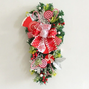 Christmas teardrop swag with candy canes red bow and artificial pine needles door decor