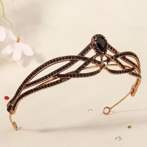 Macro detail of vintage bronze bridal crown with intricate black crystal inlay work