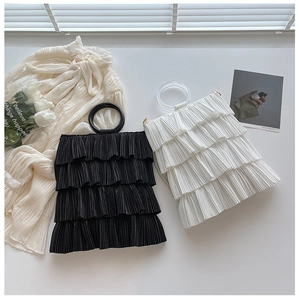 Detailed layered ruffle design of black and white tote bags with round handles