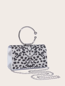 Macro shot of silver leopard print evening bag with sparkling rhinestones and metal handle