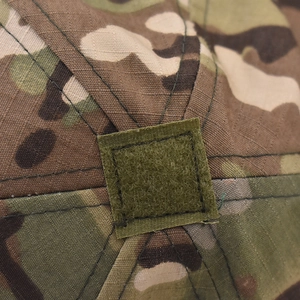 Macro detail of camouflage tactical baseball cap with top square hook and loop patch