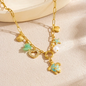 Gold charm necklace featuring enamel turtle, starfish, shell, pearl and heart charms