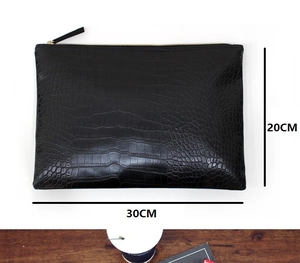 Detail of black crocodile texture envelope clutch with top zipper, 30cm width