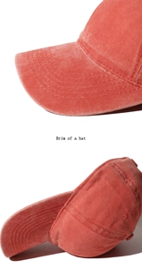 Detailed macro view showing five-line stitching on red washed vintage baseball cap brim