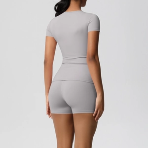 Detail view of the back of a light grey seamless high-stretch yoga shorts and top set