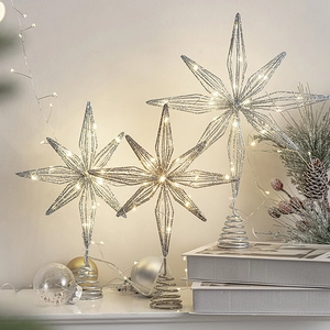 Silver glitter Christmas tree topper star with warm white LED lights for festive decor