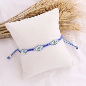 Detail of bohemian hand-woven beaded bracelet with blue seed beads and turquoise accents