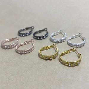 Detailed view of gold, silver, and rose gold hoop earrings with sparkling rhinestones