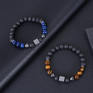 Detail of 8mm tiger eye and lava stone bracelets with square metal beads on black leather