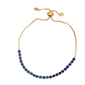 Detailed view of adjustable gold slider bracelet featuring micro-set blue zircon gemstones