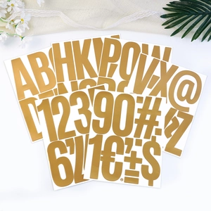 Close-up of 5 inch gold foil letter and number stickers for graduation party decor