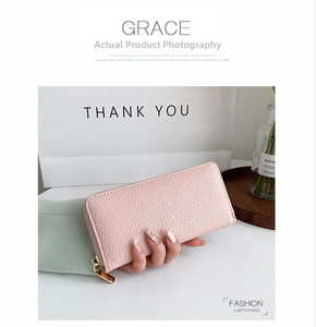 Detailed view of pink lychee grain leather wallet with high-quality gold metal zipper