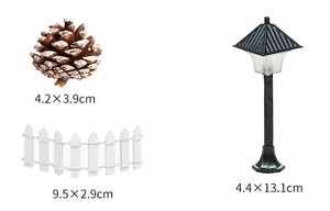 Miniature Christmas set with brown pinecone, white fence, and black street lamp models