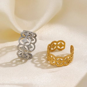 Roman-style stainless steel hollow rings in gold and silver over champagne silk