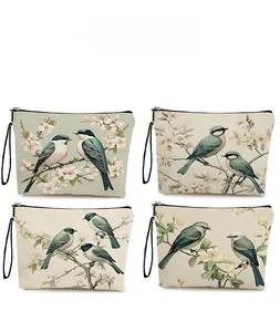 Detail showing four cream canvas makeup bags with varied kingfisher and floral patterns