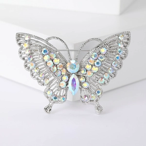Close-up of vintage butterfly brooch with rainbow AB rhinestones on silver base