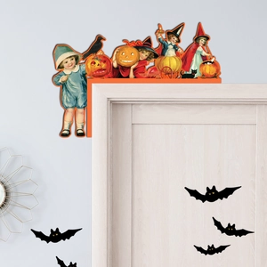 Detail of vintage Halloween wood door corner decor with pumpkin and raven illustrations