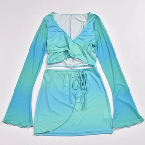 Detail of blue ombre crop top with flared sleeves and matching tie-up mini skirt