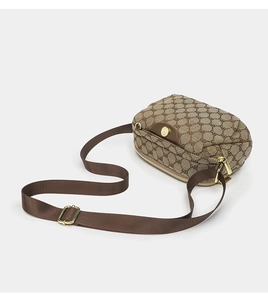 Detail of brown oxford cross-body bag featuring BM/BV letter pattern and golden hardware