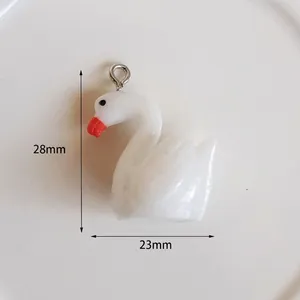 Detail view of a 28mm white swan acrylic pendant with orange beak and silver metal loop