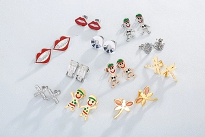 Flat lay of multiple stainless steel stud earring sets featuring enamel and zircon details