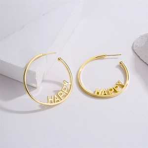 Gold plated HAPPY letter hoop earrings in 14K copper and 925 silver on white stone