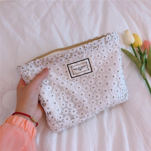 Detail of white daisy lace embroidery pouch with Time To Party text label