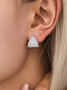 Close-up of model wearing silver triangular earrings with sparkling white cubic zirconia