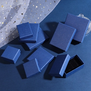 Top view of dark blue textured jewelry boxes in various sizes with elegant starry mesh