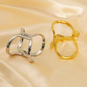Minimalist geometric gold and silver metal hair claws set on luxury champagne silk fabric