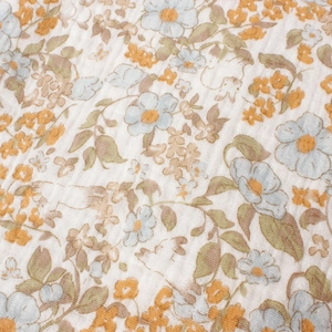 Close-up of sunflower print on double-layer cotton muslin fabric for baby blankets