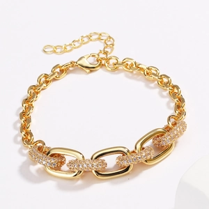 Close-up of gold-plated hip hop chain bracelet featuring pavé diamond oval links