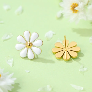 Close-up of daisy stud earrings with white enamel petals and gold plating detail