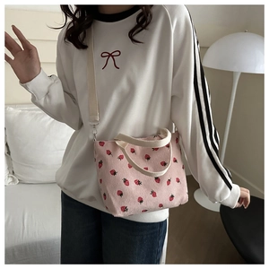 Pink corduroy tote bag with strawberry embroidery and adjustable white shoulder strap