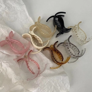Flat lay of colorful 5cm mini duckbill hair clips on a white background detail view