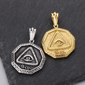 Macro shot of silver and gold stainless steel Eye of Providence octagonal pendants