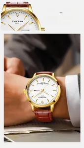 Detail of the 12 o'clock inlaid diamond and leather strap on this men's calendar watch