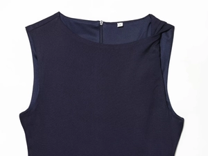 Detail view of navy blue sleeveless dress featuring shoulder rivets and back zipper