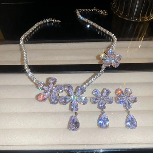 Detail shot of shimmering zircon flower necklace and matching water drop earrings set