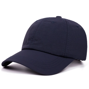 Detail of navy blue six-panel baseball cap with ventilation eyelets and curved brim